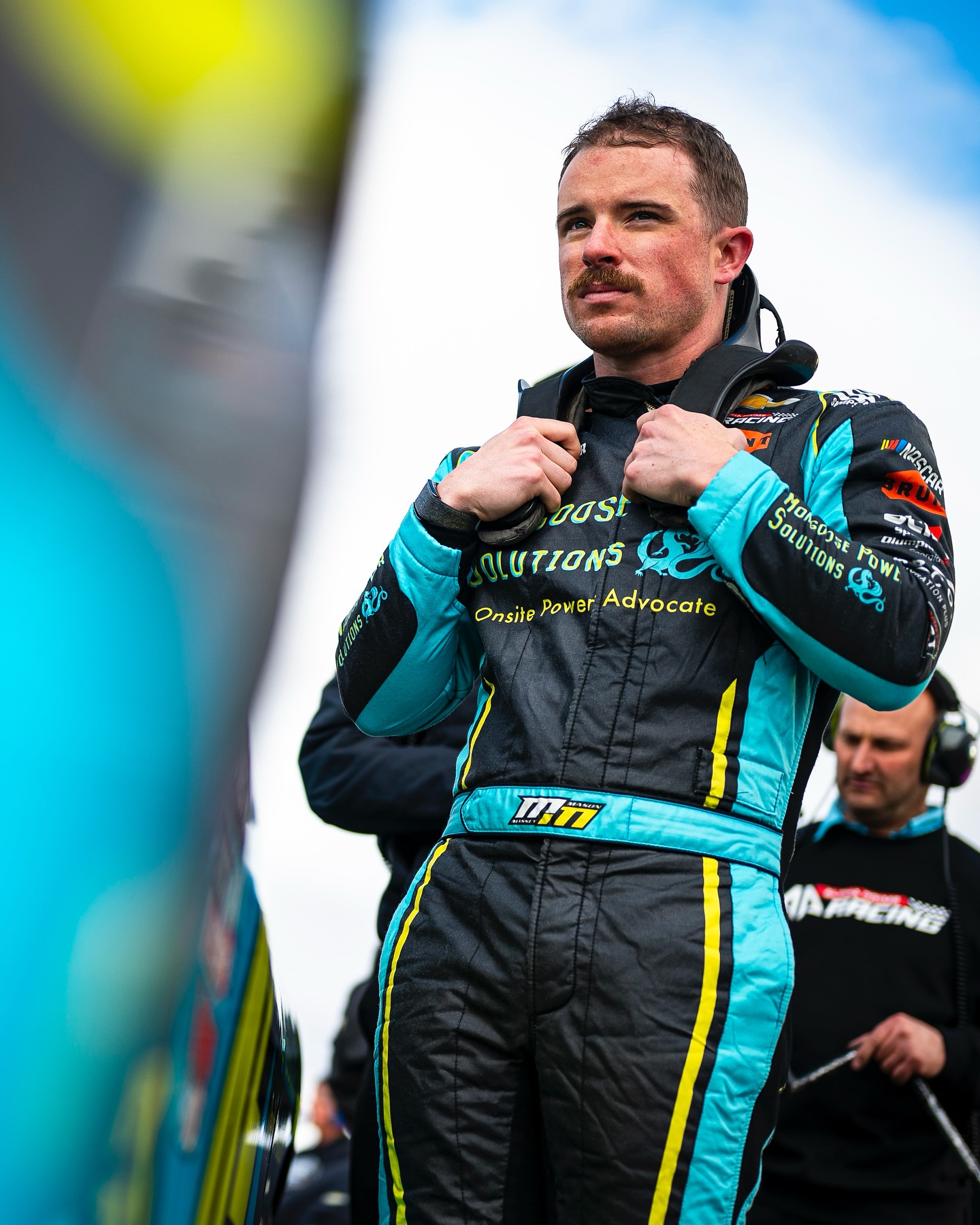 Mason Massey in his NASCAR racesuit featuring the mongoose brand.